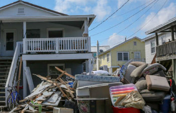 Furniture and belongings destroyed by hurricane stored in front of the house.