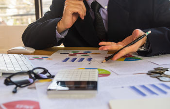 an office desk with a computer keyboard and stationeries