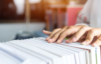 an office desk with a computer keyboard and stationeries