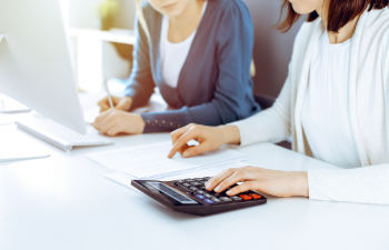 an office desk with a computer keyboard and stationeries