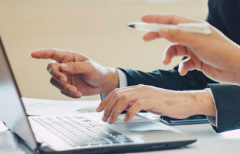 an office desk with a computer keyboard and stationeries