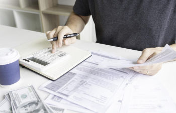 an office desk with a computer keyboard and stationeries