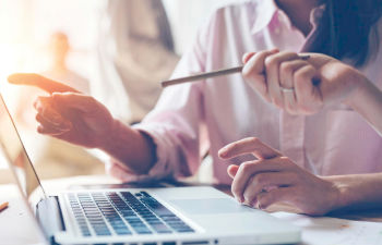 a person using disinfectant spray to clean hands