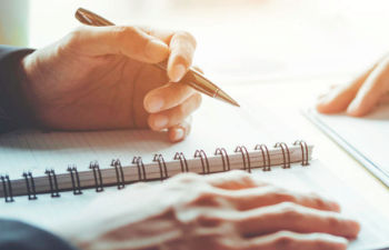 a person using disinfectant spray to clean hands