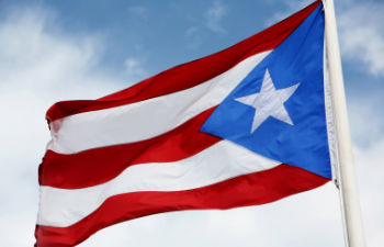 a person using disinfectant spray to clean hands