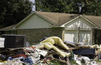 Furniture and belongings destroyed by hurricane stored in front of the house.