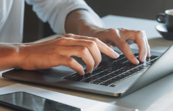 a person using disinfectant spray to clean hands